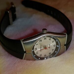 Ladies Armitron with a black rubber band and round silver face